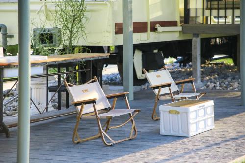 two chairs and a table on a patio at Nex Station Kanchanaburi in Kanchanaburi