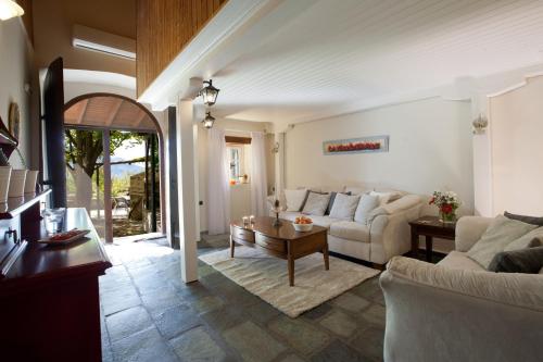 a living room with a couch and a table at Villagio Magnolia in Sívros