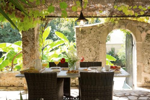 a table with food on it in an outdoor patio at Villagio Magnolia in Sívros