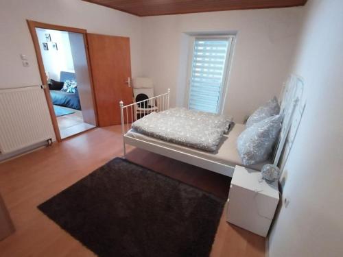 a bedroom with a bed and a living room at Ferienwohnung Ellinger in Regen