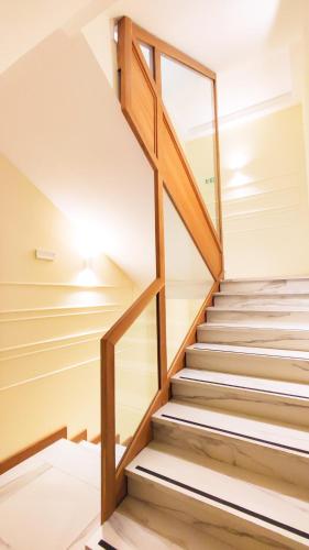 a staircase in a house with wooden railings at Catania Sea Palace Hotel in Catania