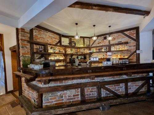 a bar in a restaurant with a brick wall at Hotel Górski in Wolbórz