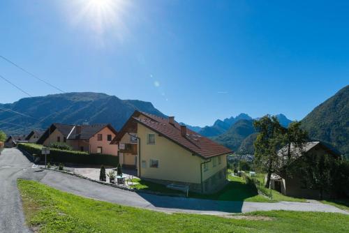 a village with houses and mountains in the background at Ela Apartments - 2 in Dovje
