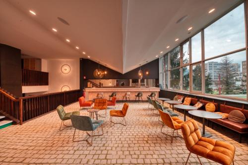a lobby with tables and chairs and a bar at COWOOL GRENOBLE in Grenoble