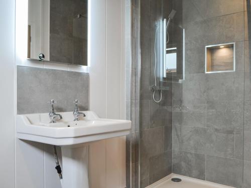 a bathroom with a sink and a shower at The Alpaca Lodge in Arlecdon