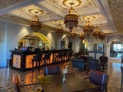a bar in a restaurant with tables and chairs at Jumeirah Zabeel Saray Dubai in Dubai