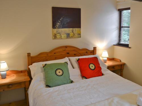 a bedroom with a bed with two pillows on it at The Granary in Knapton