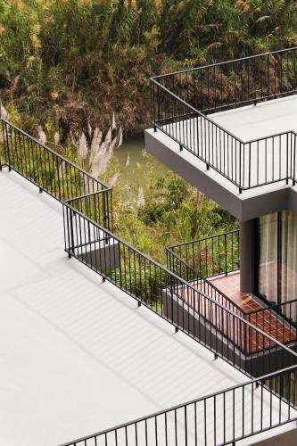 a house with black metal railings on a deck at Sirinati Khao Kho in Khao Kho