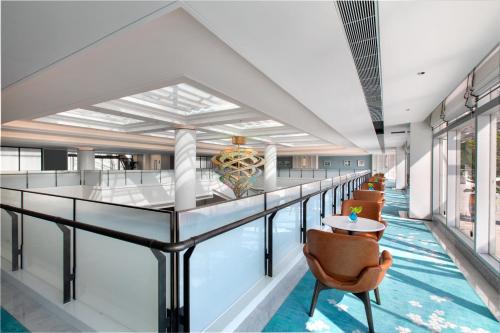 a view of the lobby of a hotel with a pool at Xiamen International Seaside Hotel -Hotel corridor leads to the stone exhibition hall in Xiamen