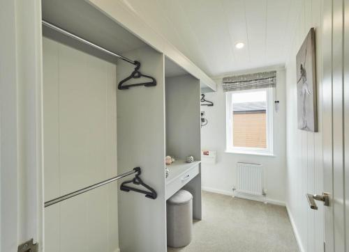 a hallway with a door leading to a bathroom at Cherry Blossom 48 Hot Tub in Garton