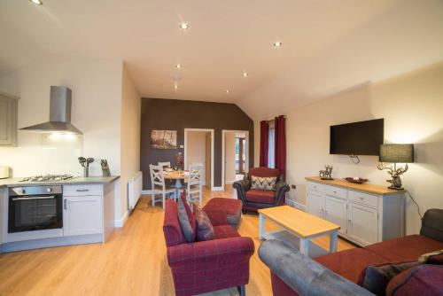 a kitchen and living room with a couch and a table at Hawthorn 19 Hot Tub in Garton