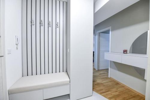 a white staircase with a bench in a room at Petar's aparment luxury new in Skopje