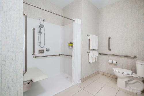 a white bathroom with a shower and a toilet at Holiday Inn Express & Suites Kelowna - East, an IHG Hotel in Kelowna