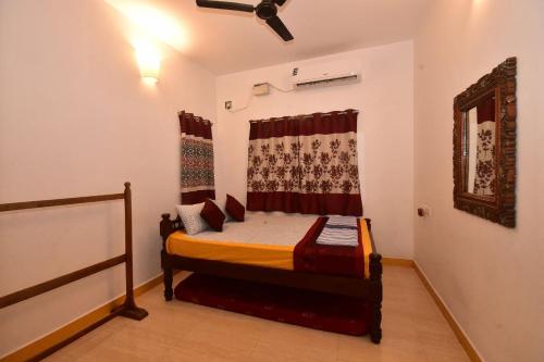 a bedroom with a bed in a room at Dj Villa in Puducherry