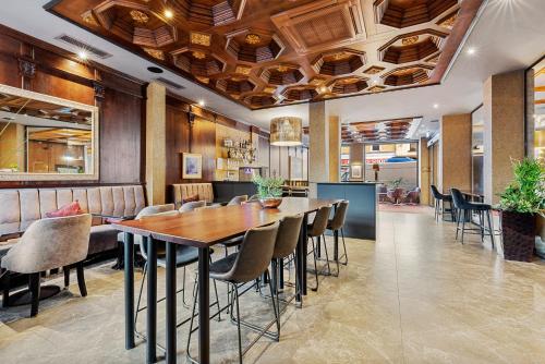 a dining room with a table and chairs at KING's Hotel First in Munich
