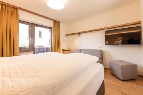 a hotel room with two beds and a window at Pension Gulla - Ferienhaus Appartements B&B in Neustift im Stubaital