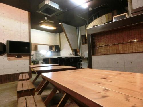 a room with wooden tables and benches in a kitchen at 潮風room@SUN(シオカゼルームアットサン) in Chikura