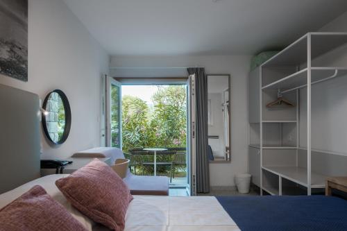 a bedroom with a bed and a door to a patio at Holiday Park Vile - Terme Krka in Strunjan