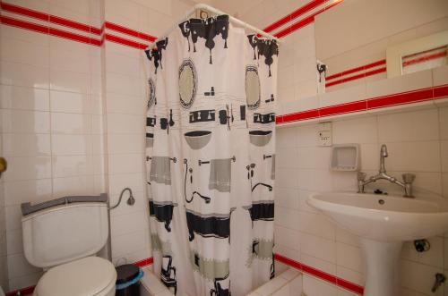 a bathroom with a toilet and a sink at Almira Inn in Ios Chora