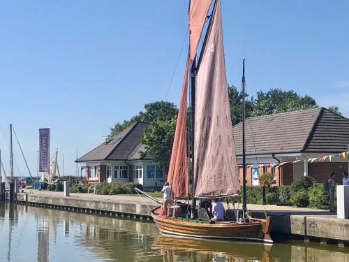 a sail boat is docked at a dock at Haus 1795 Stieglitz in Wustrow