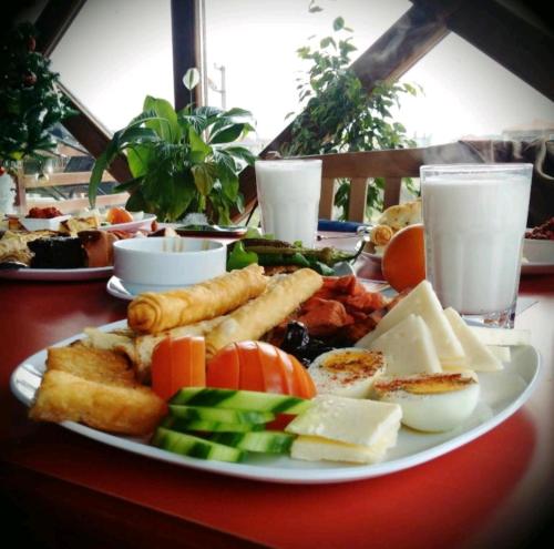 a plate of cheese and other foods on a table at Private Apartment in Grand Monastery in Pamporovo