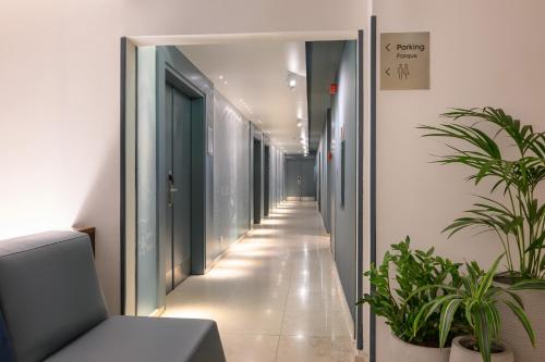 an empty corridor in an office with plants at Melia Lisboa Oriente Hotel in Lisbon