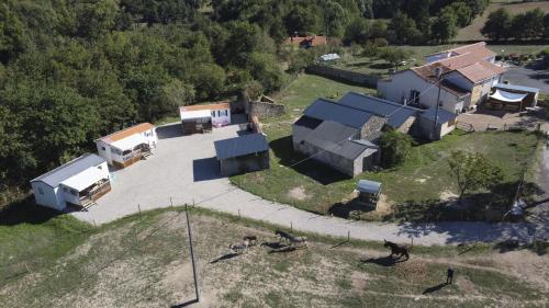 an aerial view of a village with a house at Camping de la ferme aux ânesses, mobil home myrtille in Bressuire