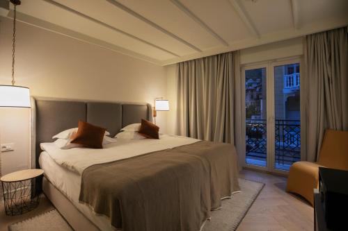 a bedroom with a large bed and a balcony at Amadria Park Grand Hotel 4 Opatijska Cvijeta in Opatija