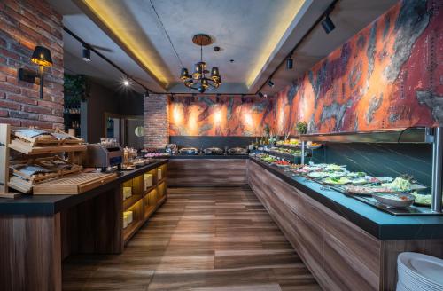 a restaurant with a long counter with food at Levor Hotel in Bursa