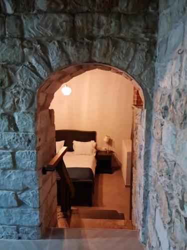 a room with a bed in a stone wall at וילה תהילה המחודש - The new Villa Tehila in Rosh Pinna