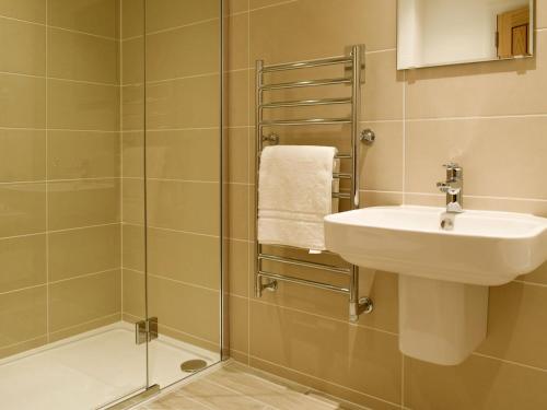 W łazience znajduje się umywalka i prysznic. w obiekcie Kenmore Lodge w mieście Kenmore