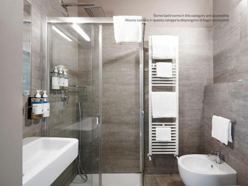 a bathroom with a shower and a sink and a toilet at Numa Florence Rodo in Florence