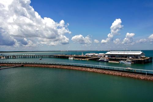 a marina with boats on the water and clouds at Serenity Deja Blue - at Darwin Waterfront in Darwin