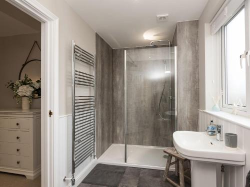 a bathroom with a shower and a sink at River Quay in Gorleston-on-Sea