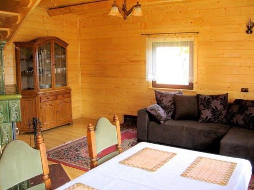 a living room with a couch and a table at Domek na Zabawie in Milówka