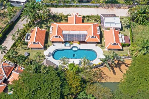an aerial view of a house with a swimming pool at Villa Carlos, Luxury 7 BDR Private Pool Villa, Baan Bua Nai Harn, Phuket in Rawai Beach