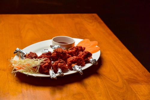 a plate of food on a table with a cup of coffee at Kuruva Island Resort And Spa - By KABINI BREEZE in Mananthavady