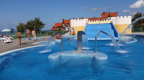 a water park with a water slide in a pool at Szatmári Vendégház in Balatonlelle