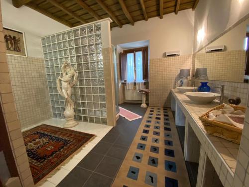 a bathroom with a shower and a sink and a tub at Antico Casale Edifizio in Viterbo