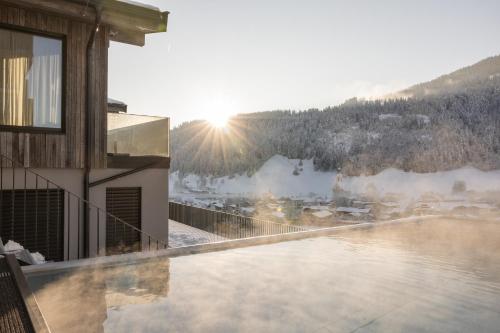 a balcony with a view of a snow covered mountain at GOING TRIPLE A apartments WEST in Going