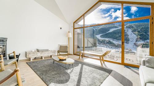 a living room with a large window with a view at KOKONO Luxury Ski Chalet Andorra, El Tarter in El Tarter