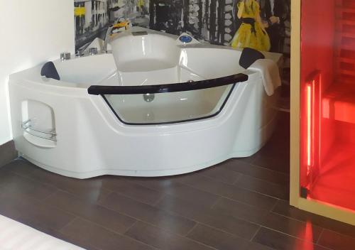 a white bath tub sitting on the floor in a room at ARTEMIDE "Fiore Club" B&B SUITE SPA in Giffoni Valle Piana