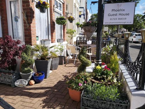 a street with potted plants and a guest house sign at The Phoenix Guest House in Scarborough