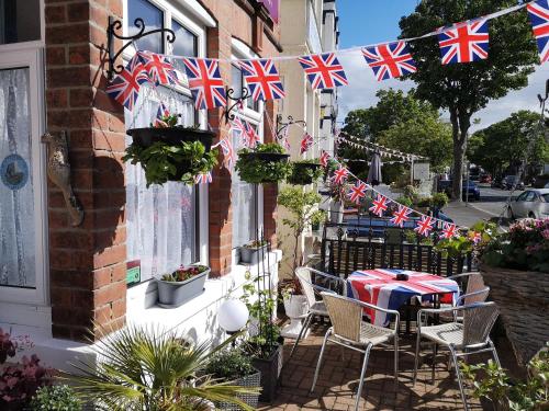 a patio with a table with british flags on it at The Phoenix Guest House in Scarborough