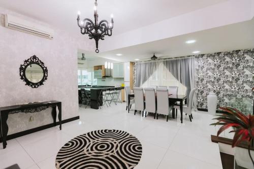 a dining room and living room with a chandelier at Luxury House near KL City for Vacation and Retreat in Ampang