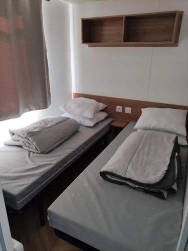 Postel nebo postele na pokoji v ubytování Mobilhome St Georges d'Oléron