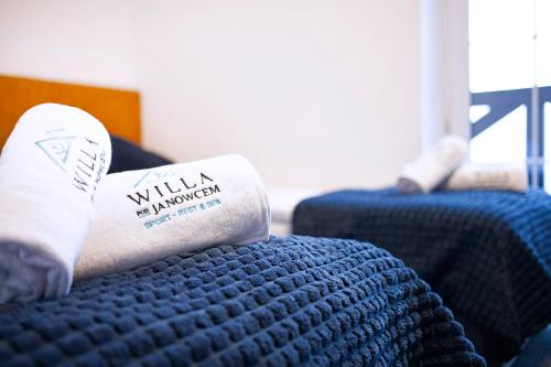 a person laying on a bed with a pillow on it at Willa Pod Janowcem SPORT - REST & SPA in Stronie Śląskie