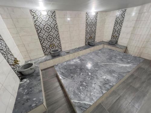 a bathroom with a shower with a concrete floor at ERCİYES HİLL in Erciyes