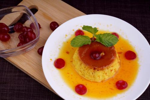 a plate of food with a dessert in the shape of a pineapple at Hotel Sifat International in Surat
