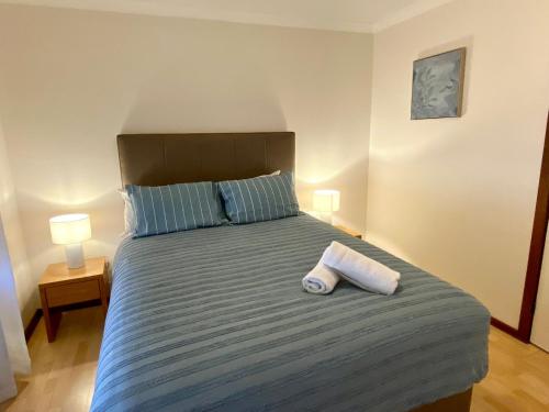 a bedroom with a bed with two towels on it at Forrest Holiday Unit Bunbury in Glen Iris